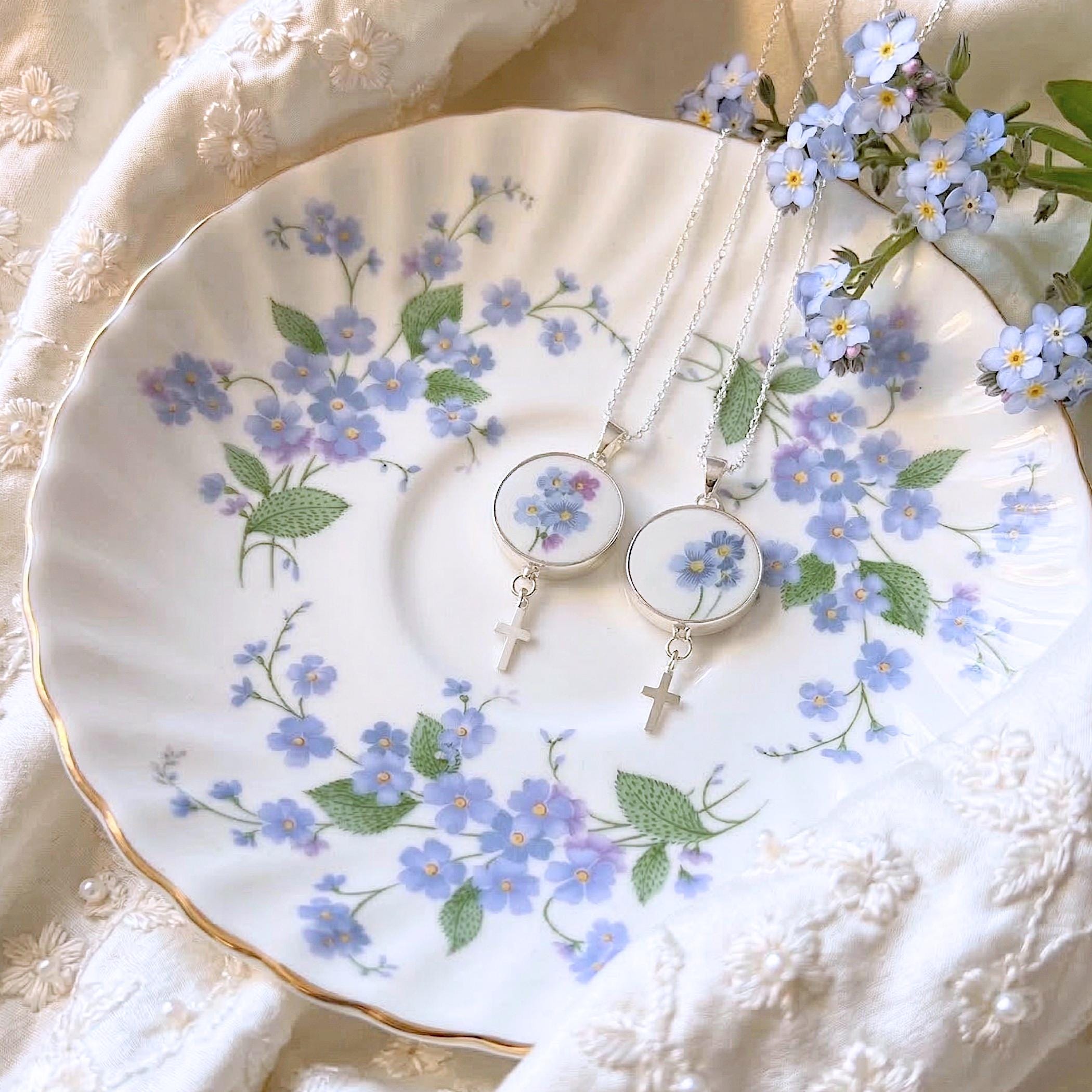 Dainty cross necklace with forget me not china pendant displayed on matching vintage Paragon plate, sterling silver broken china jewelry