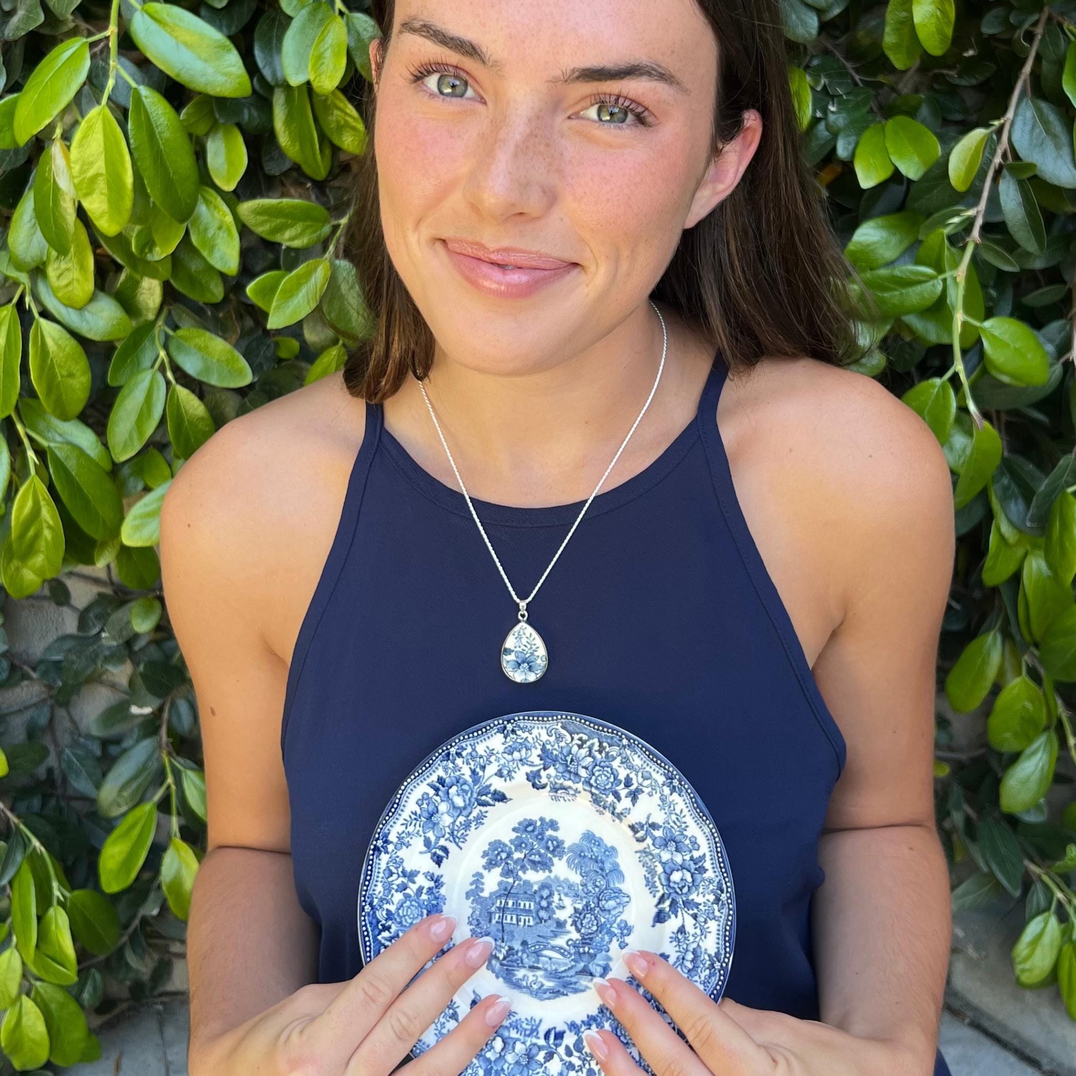 Blue and white Staffordshire china necklace worn, showing the chinoiserie pattern set in sterling silver.