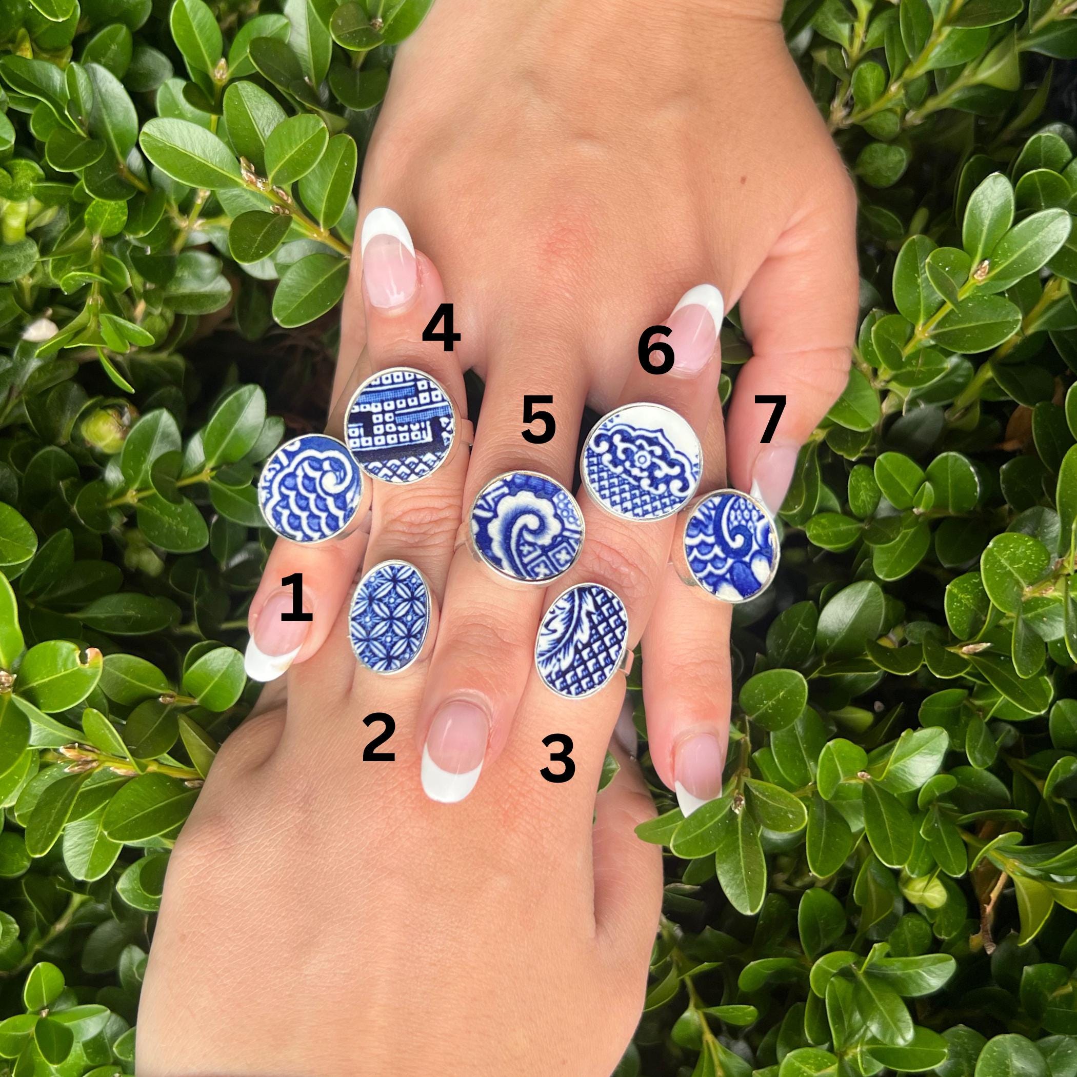 Up-close of seven Blue Willow China Rings, upcycled from repurposed Blue Willow china plate, blue and white porcelain jewelry gift for her.