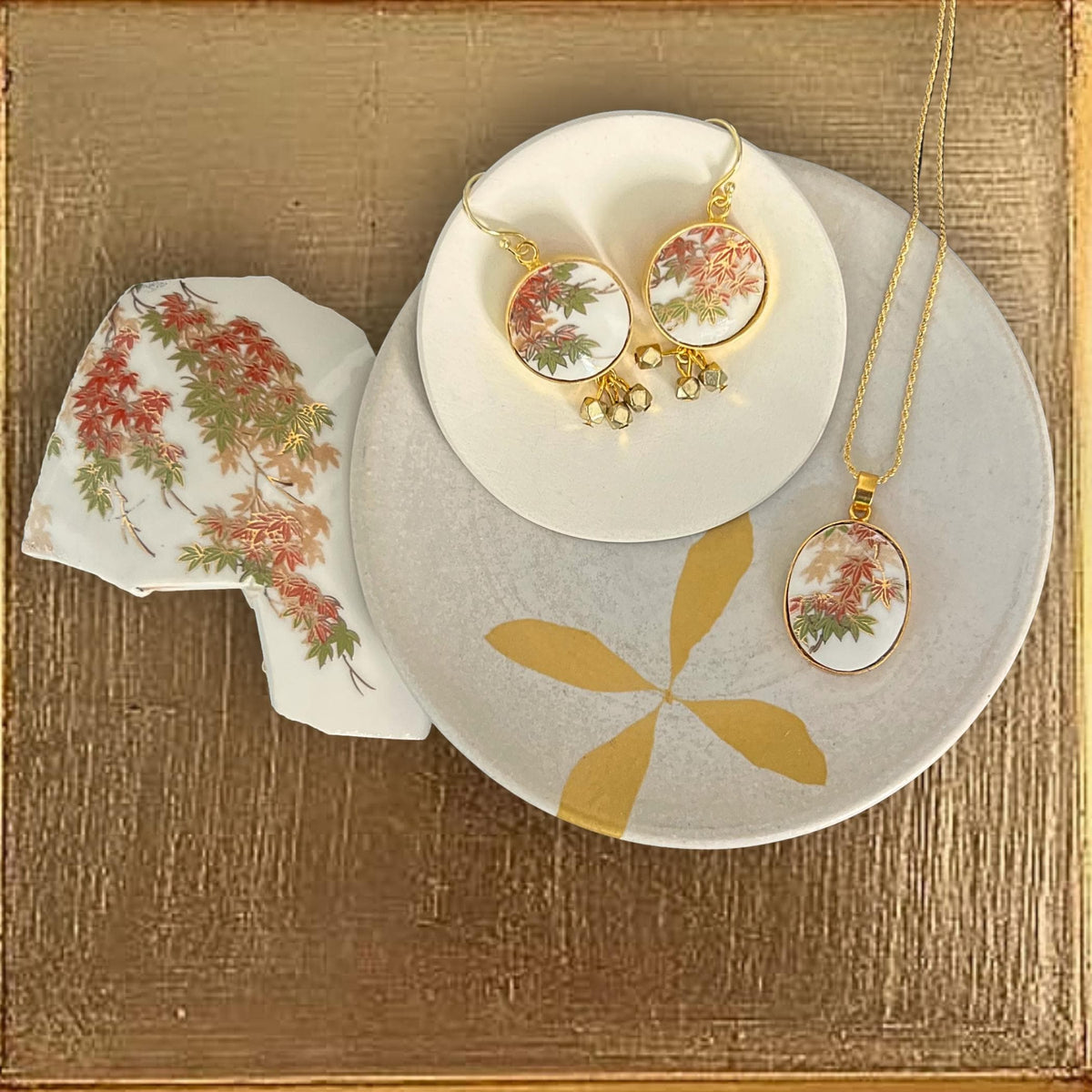 Stunning Autumn maple leaf jewelry set displayed with the Japanese Imari porcelain it was handmade from.