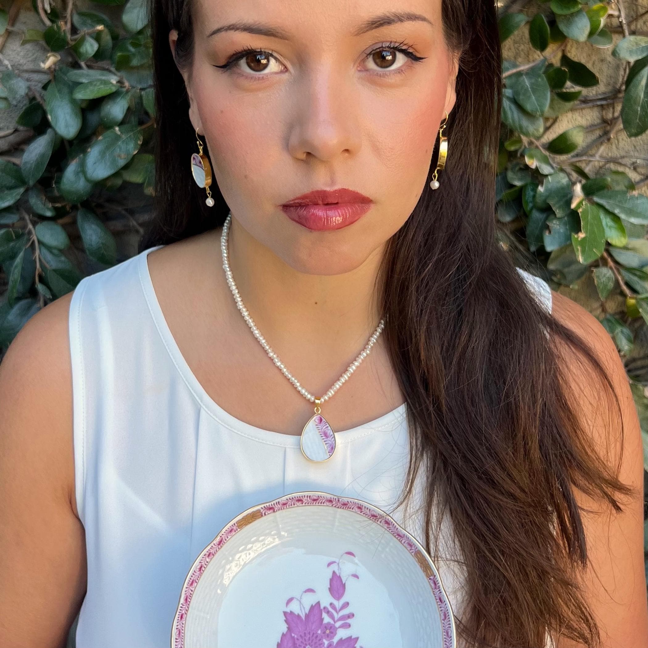 Raspberry Herend Chinese Bouquet china pendant with pearl necklace and earrings worn together, showing the pendant length at the collarbone.