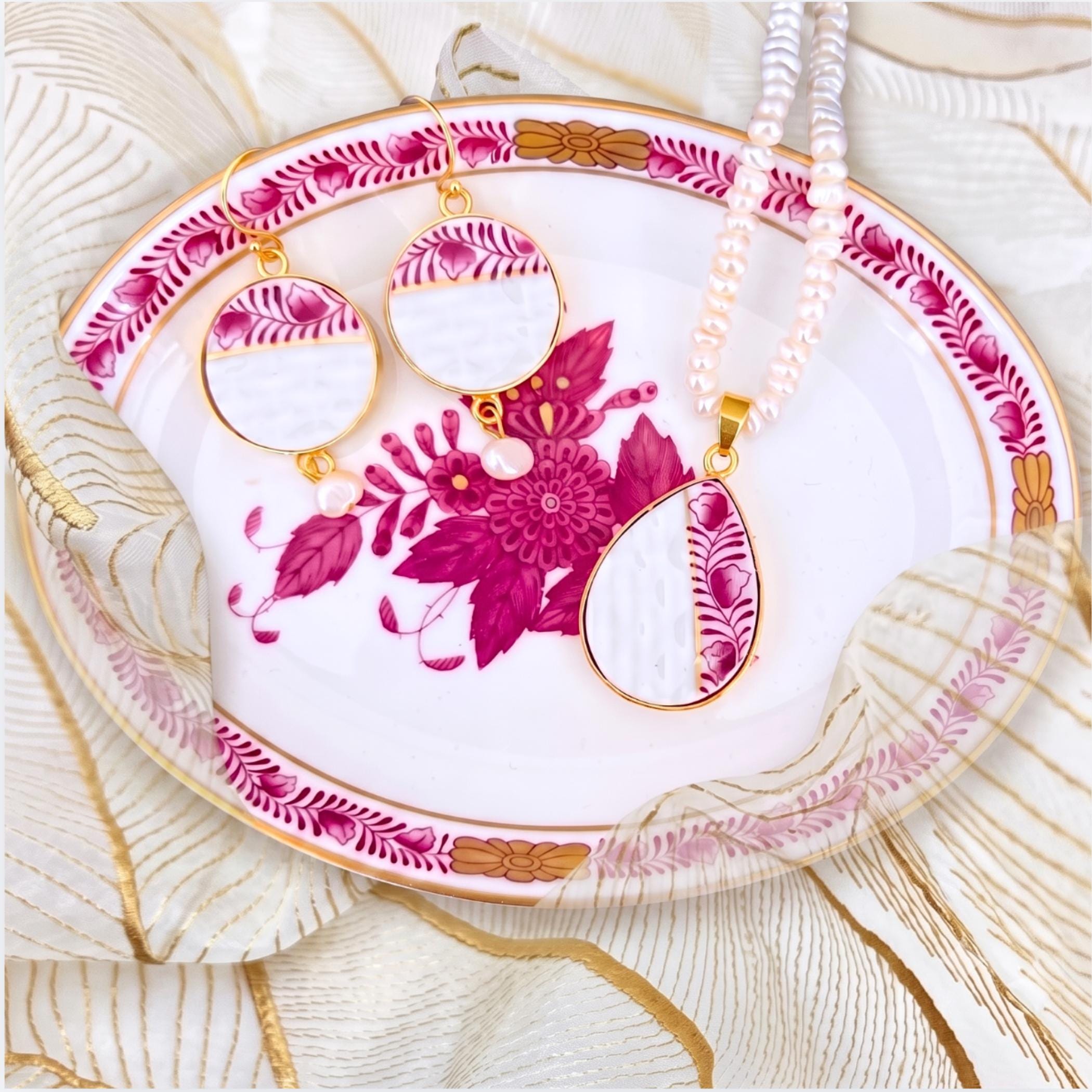 Herend Chinese Bouquet china necklace and earrings set in the Raspberry color, displayed on the matching antique trinket dish.