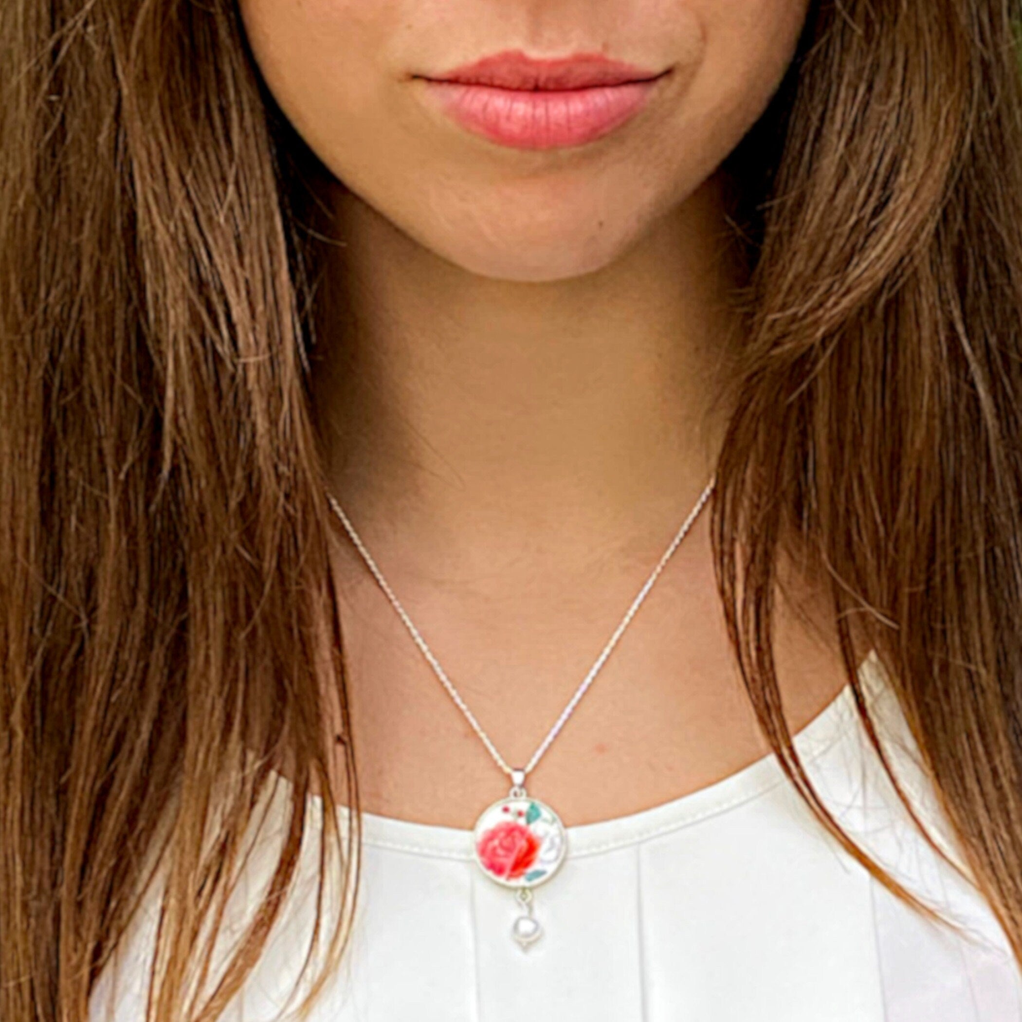 Model wearing this Vintage Christmas Red Rose China Necklace with sterling silver chain and broken china pendant.