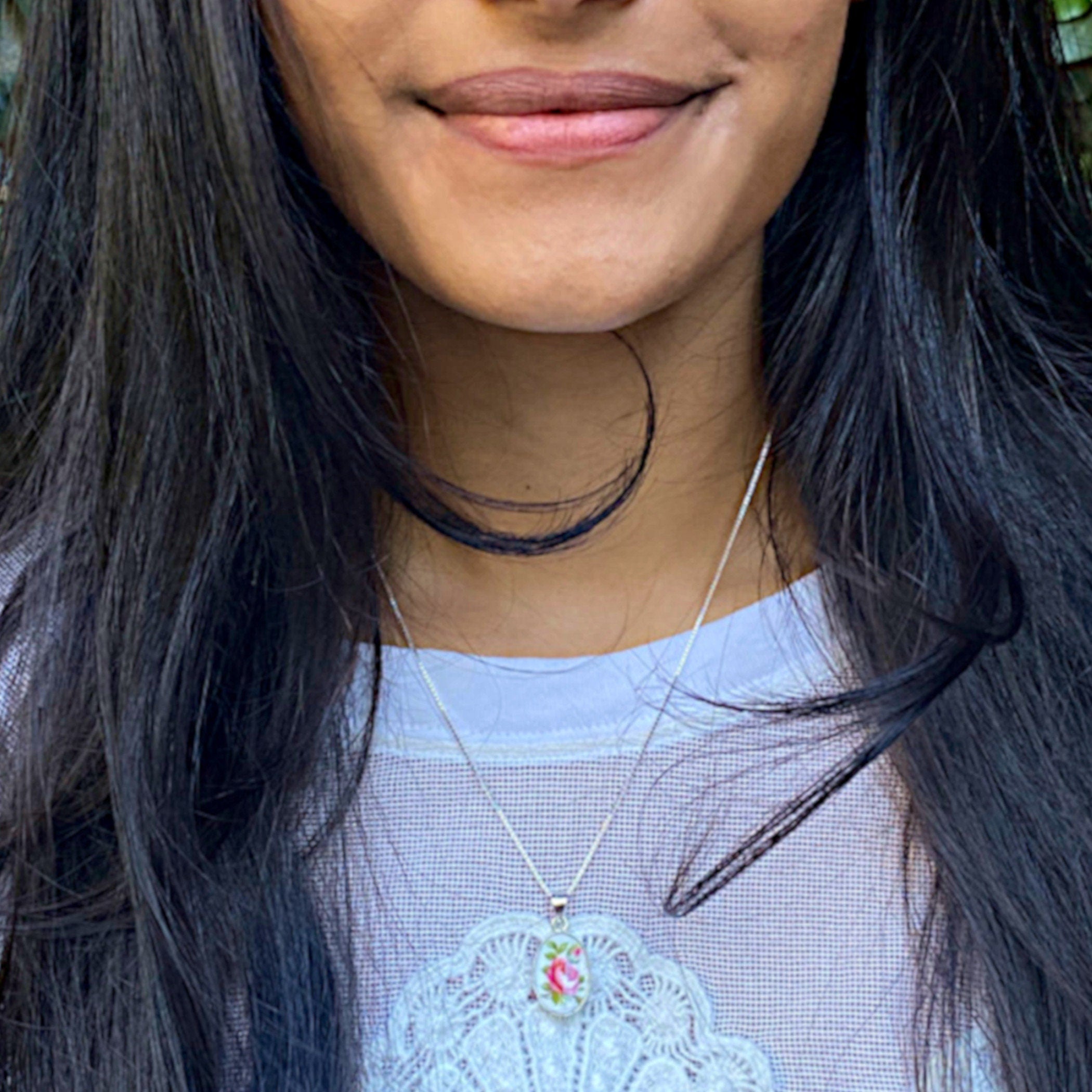 Model wearing this Royal Albert broken china necklace with a sterling silver chain in 16" or 18" and sweet rose china pendant.