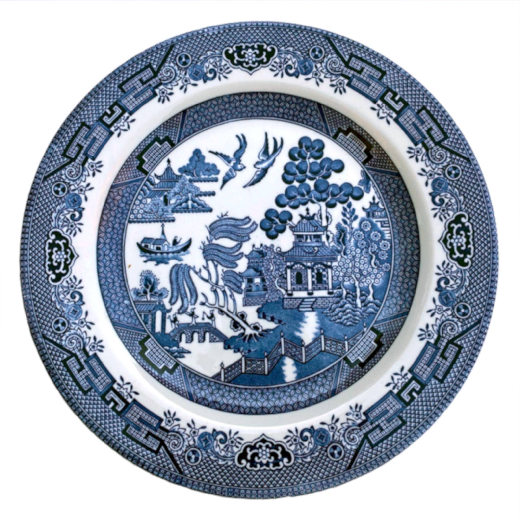May include: A vintage Blue Willow china plate. The blue and white china plate features a central image of a pagoda, trees, and a bridge. The border of the plate is decorated with a repeating pattern of stylized flowers and leaves.