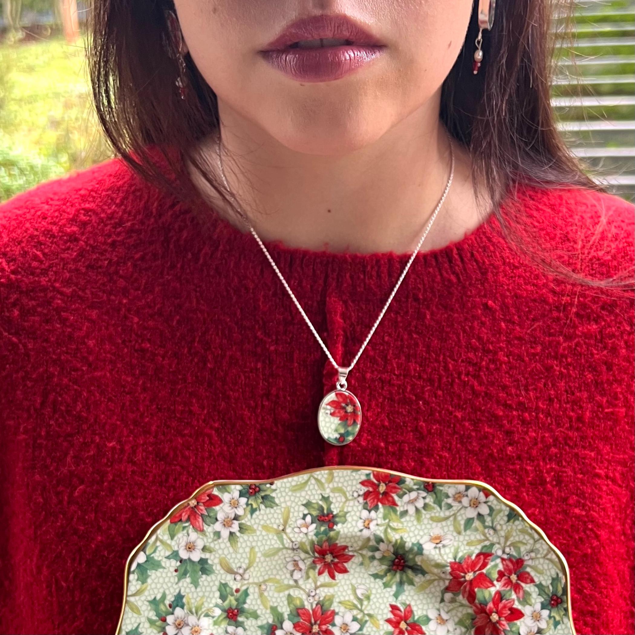 Woman wearing red poinsettia china necklace vintage Royal Winton Christmas jewelry handmade with broken china sterling pendant