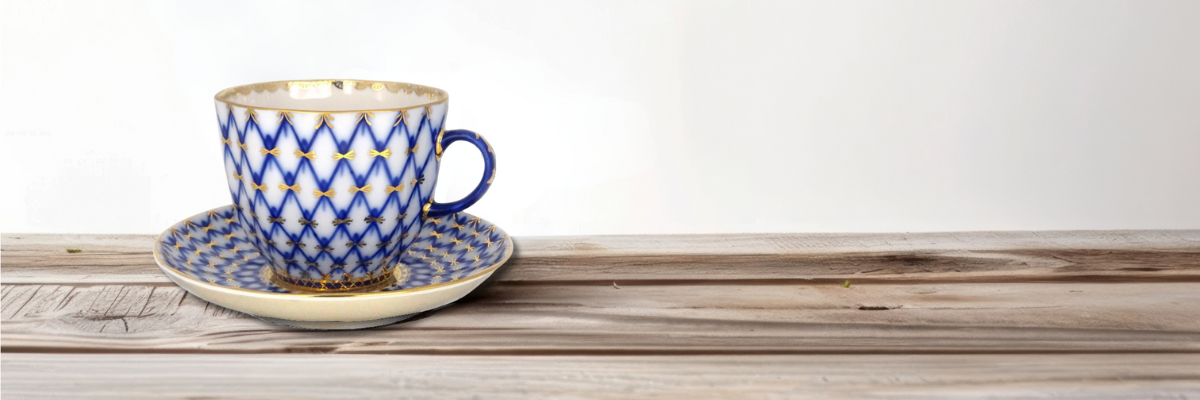 Lomonosov Cobalt Net pattern featuring deep blue intersecting lines with gold star accents on white porcelain