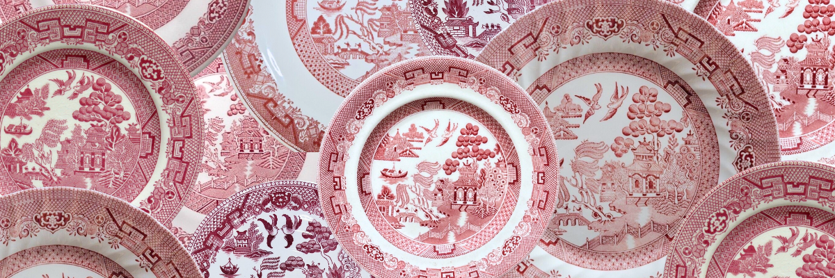 Photo collage of vintage Red Willow china plates showcasing the classic Blue Willow pattern reimagined in striking crimson hues, transforming the traditional blue and white design into rich red transferware. 
