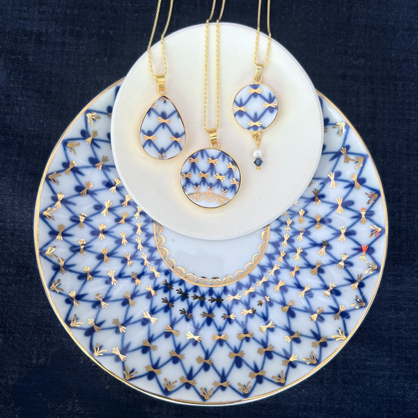Close-up of handcrafted Lomonosov Cobalt Net porcelain necklace pendant in gold-plated sterling silver setting