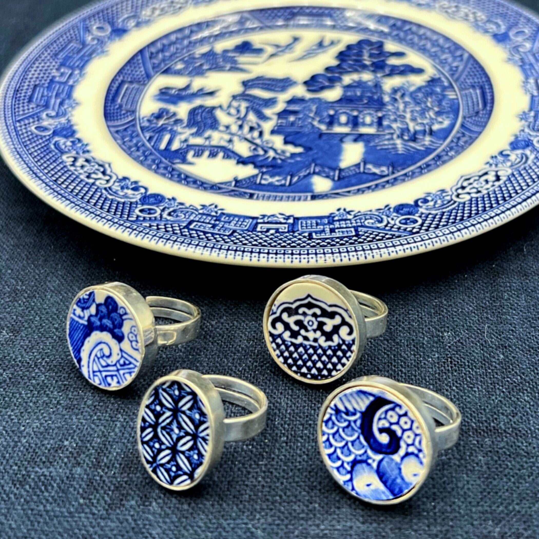 Blue and white Blue Willow china rings displayed on the antique Blue Transferware plate they were upcycled from.