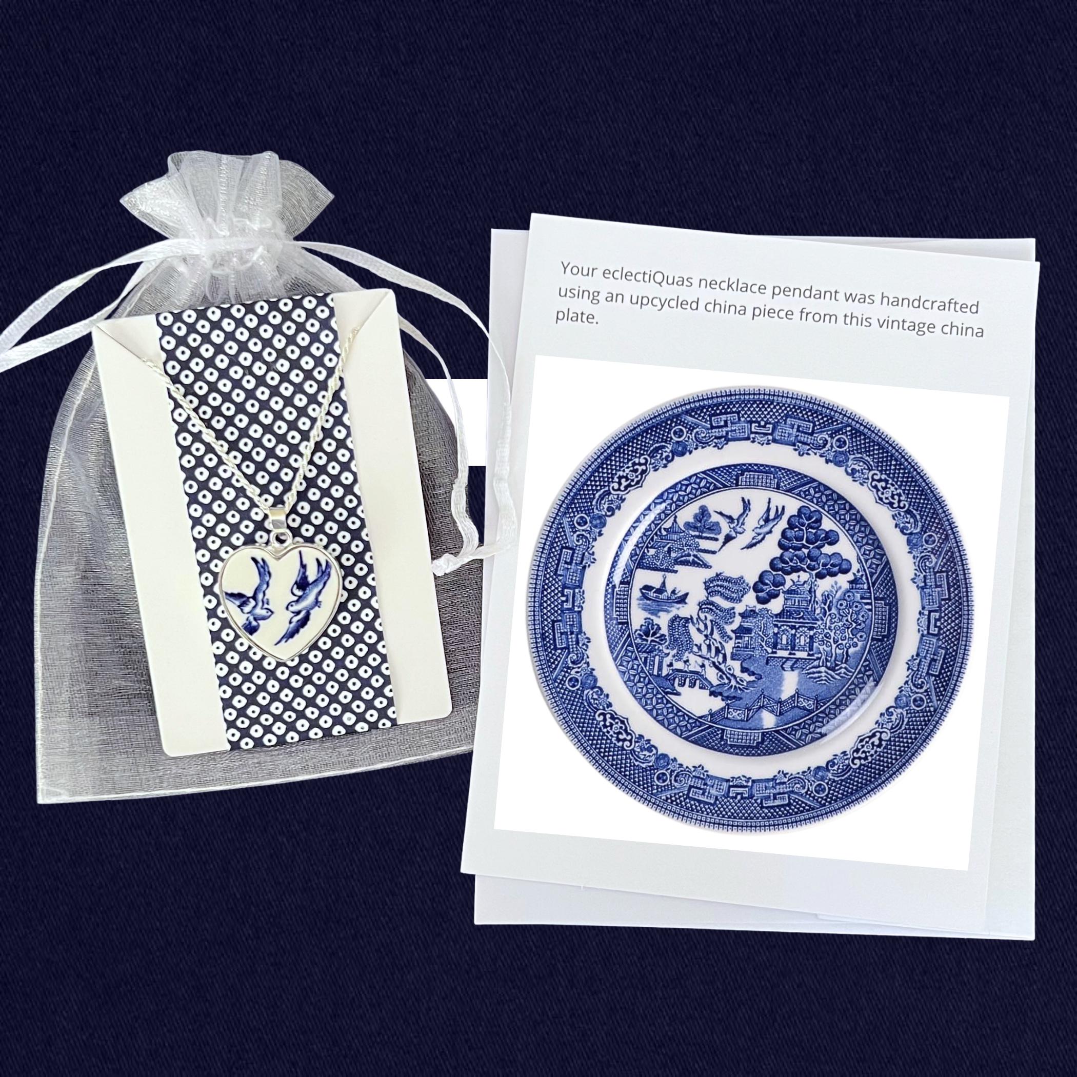 Blue Willow Love Birds heart necklace on a white organza jewelry bag with a photo card of the china plate it was made from.