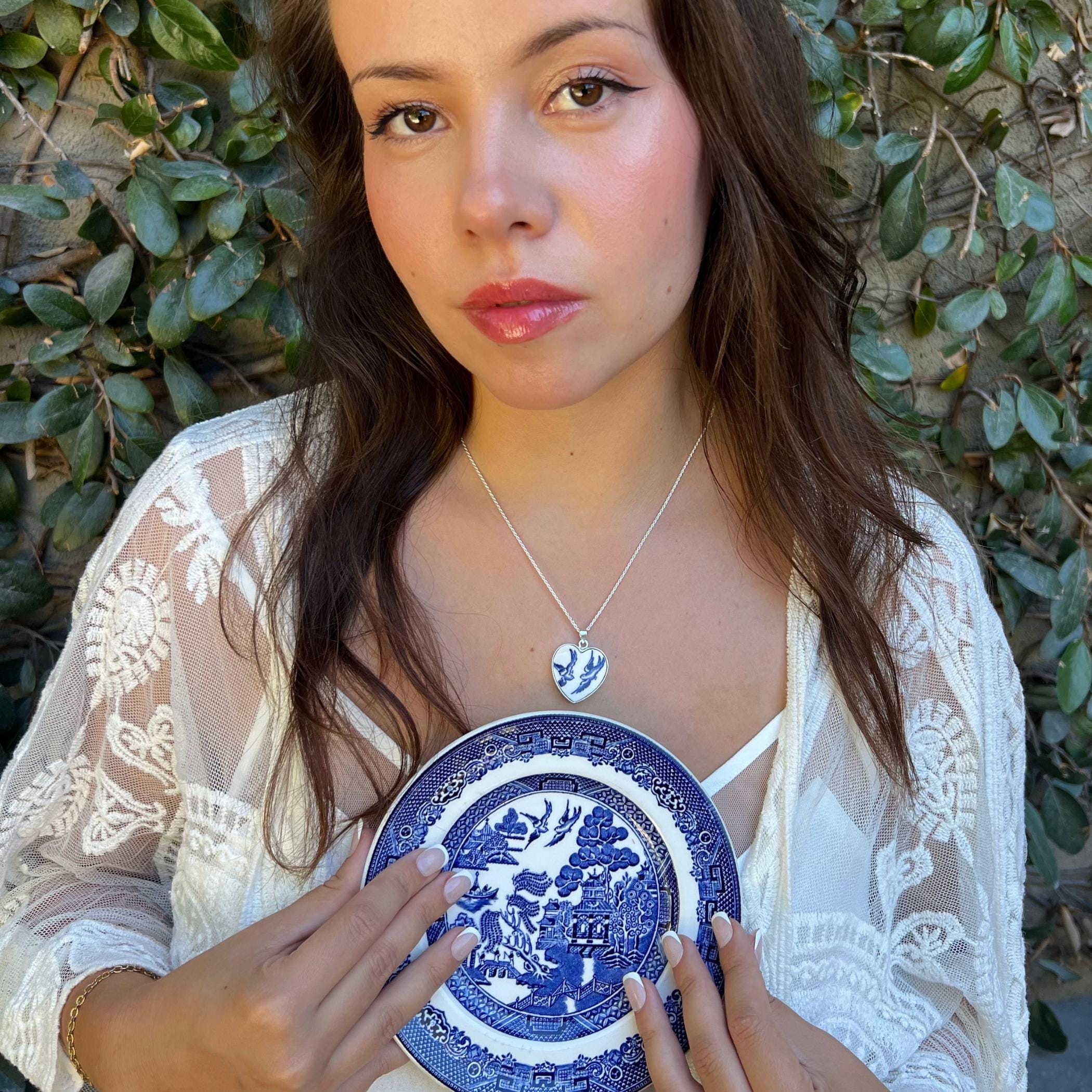 Blue Willow Love Birds heart necklace worn to show size and shape, featuring the heart-shaped pendant setting.