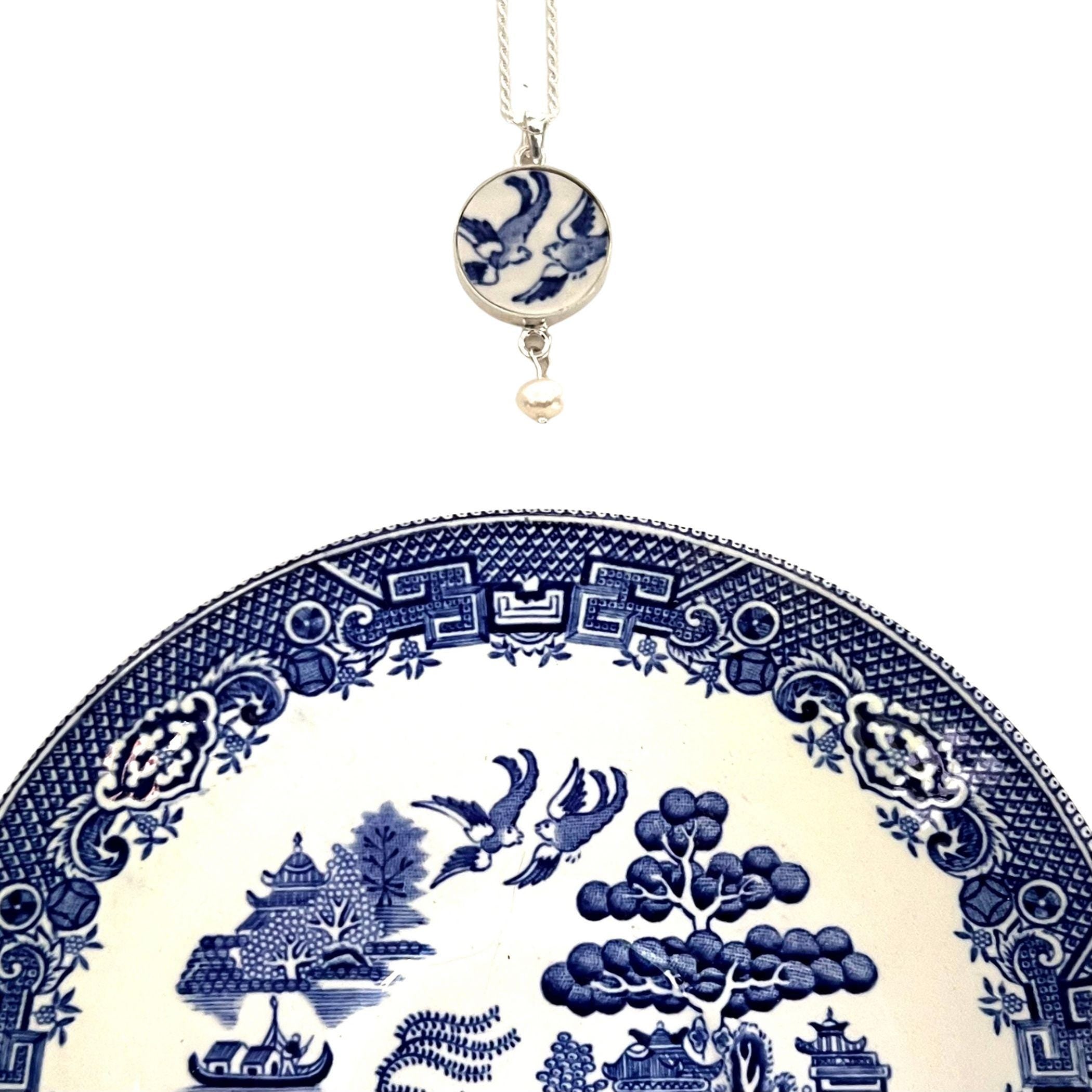 Round Blue Willow Love Birds pendant necklace with a pearl dangle, cut from a vintage china plate.