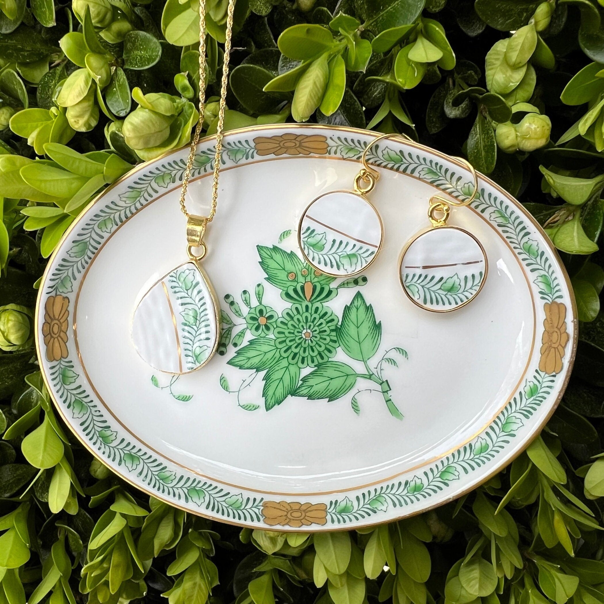 Green Herend Chinese Bouquet Apponyi porcelain necklace and earrings displayed on an antique trinket dish.