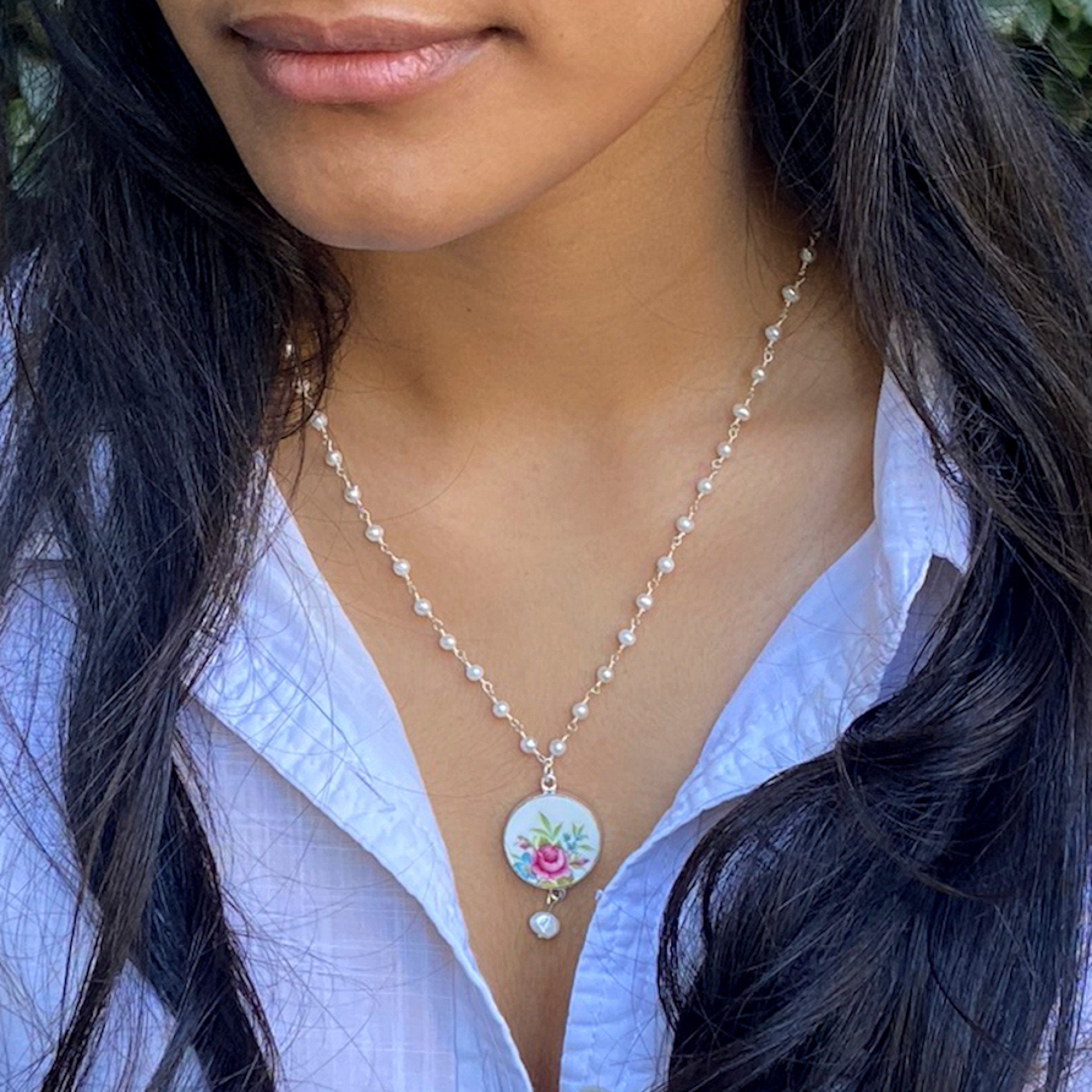 Model wearing this Pink Rose China Necklace with a tiny pearl chain and vintage rose broken china pendant.