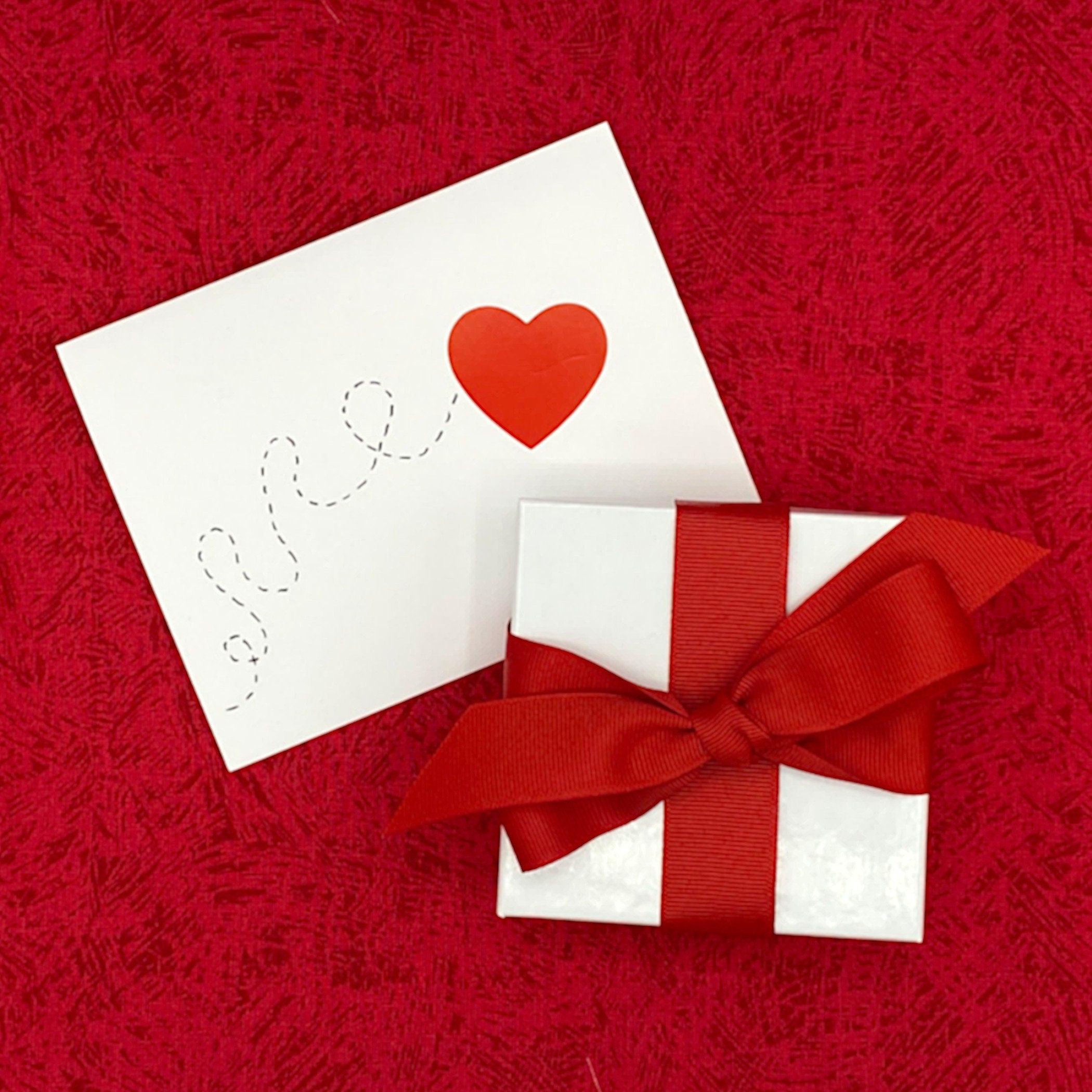 FREE HOLIDAY GIFT WRAP: a white box with a red ribbon, and a decorative fabric strip inside each box corresponding to the design and color of each jewelry item, and a handmade gift card.