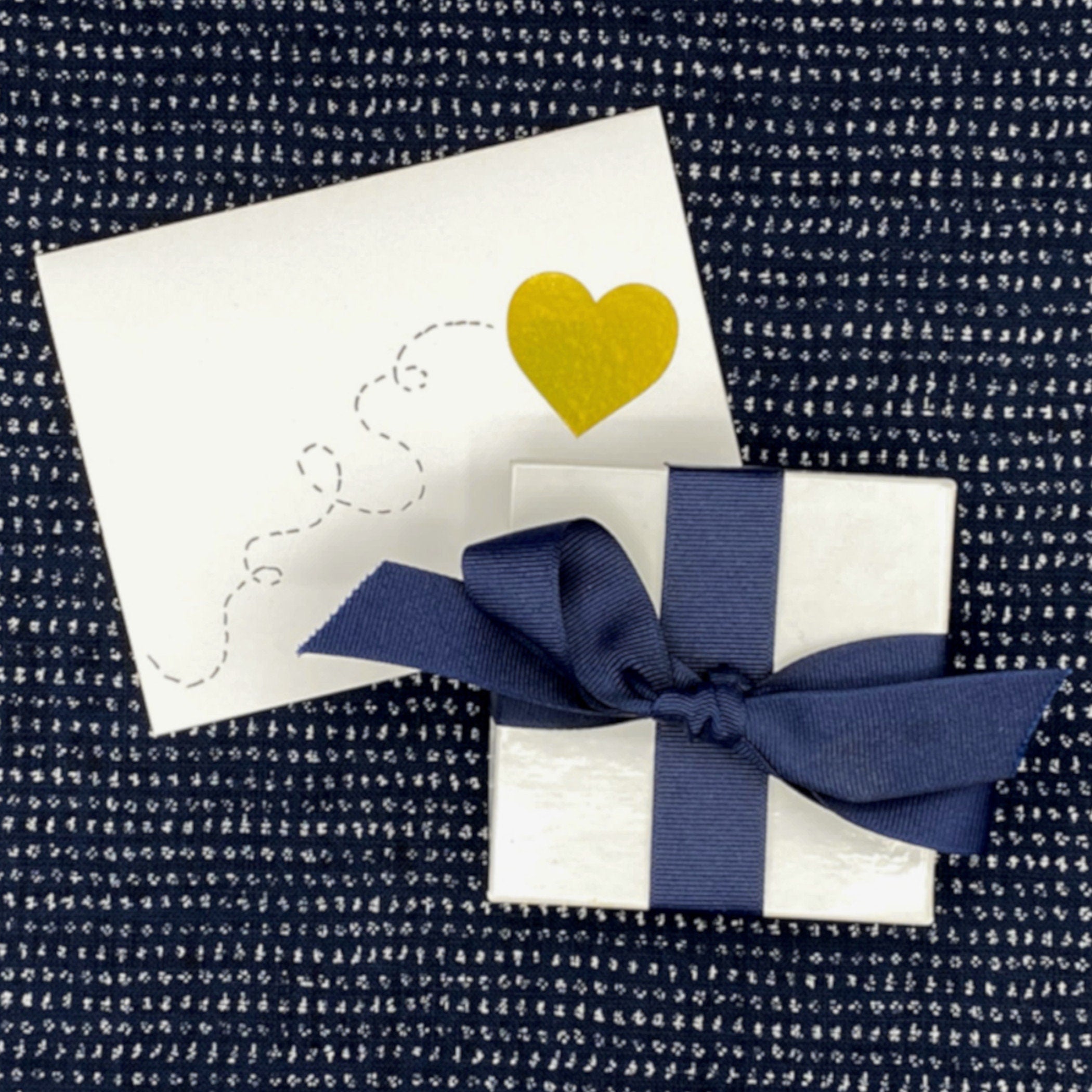 FREE GIFT WRAP: a white box with an indigo ribbon, and a decorative fabric strip inside each box corresponding to the design and color of each jewelry item, and a handmade gift card.